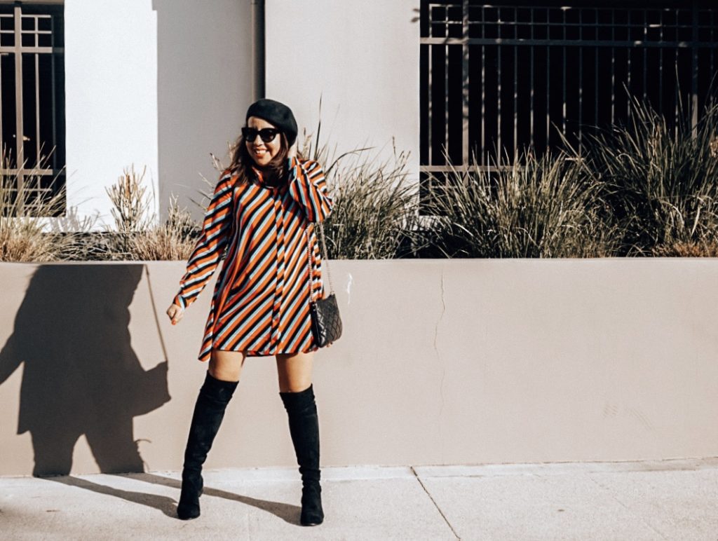 Girl in striped mod dress and beret.