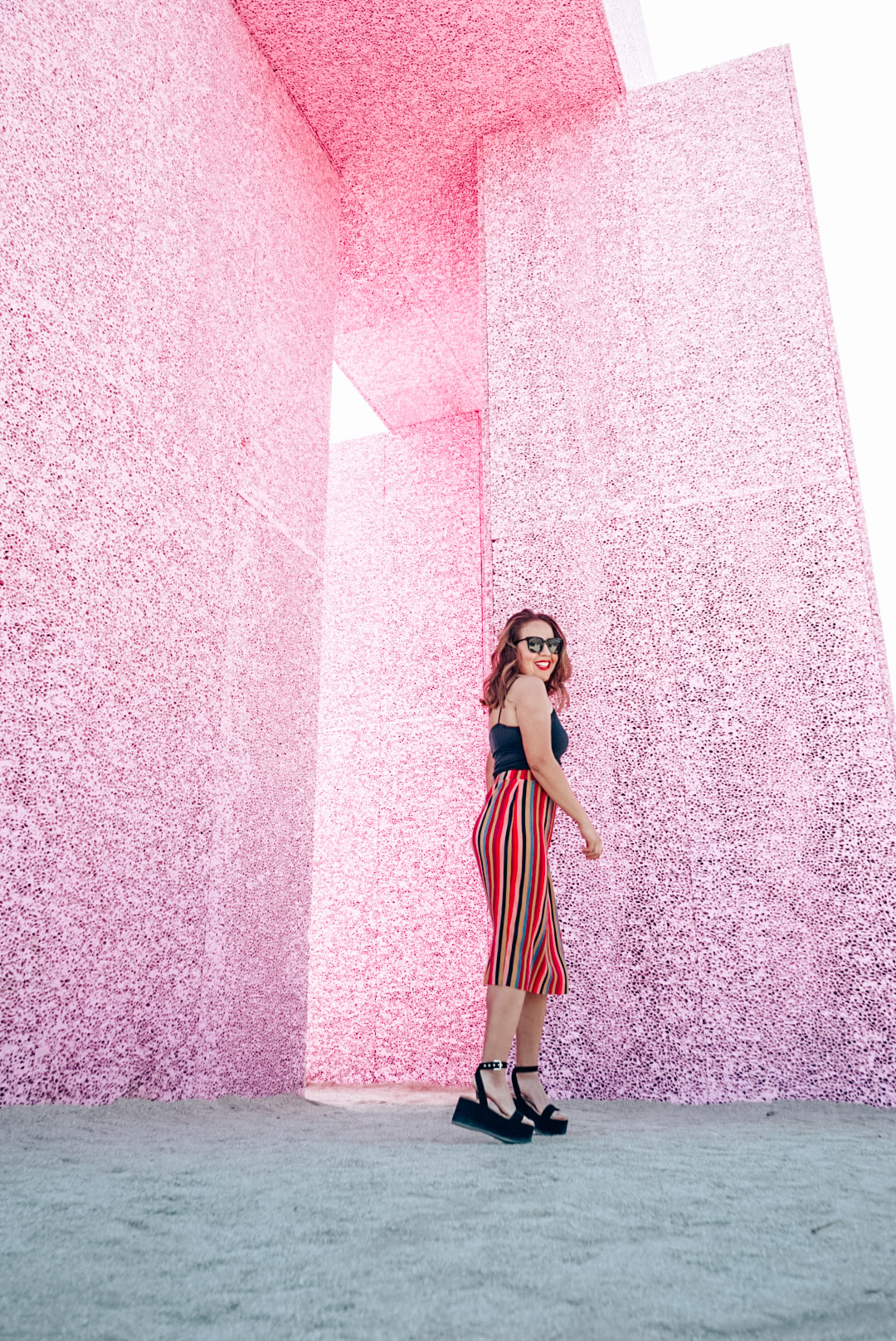 Girl in skirt in front of the Super Flex art exhibit in the Coachella Valley. 