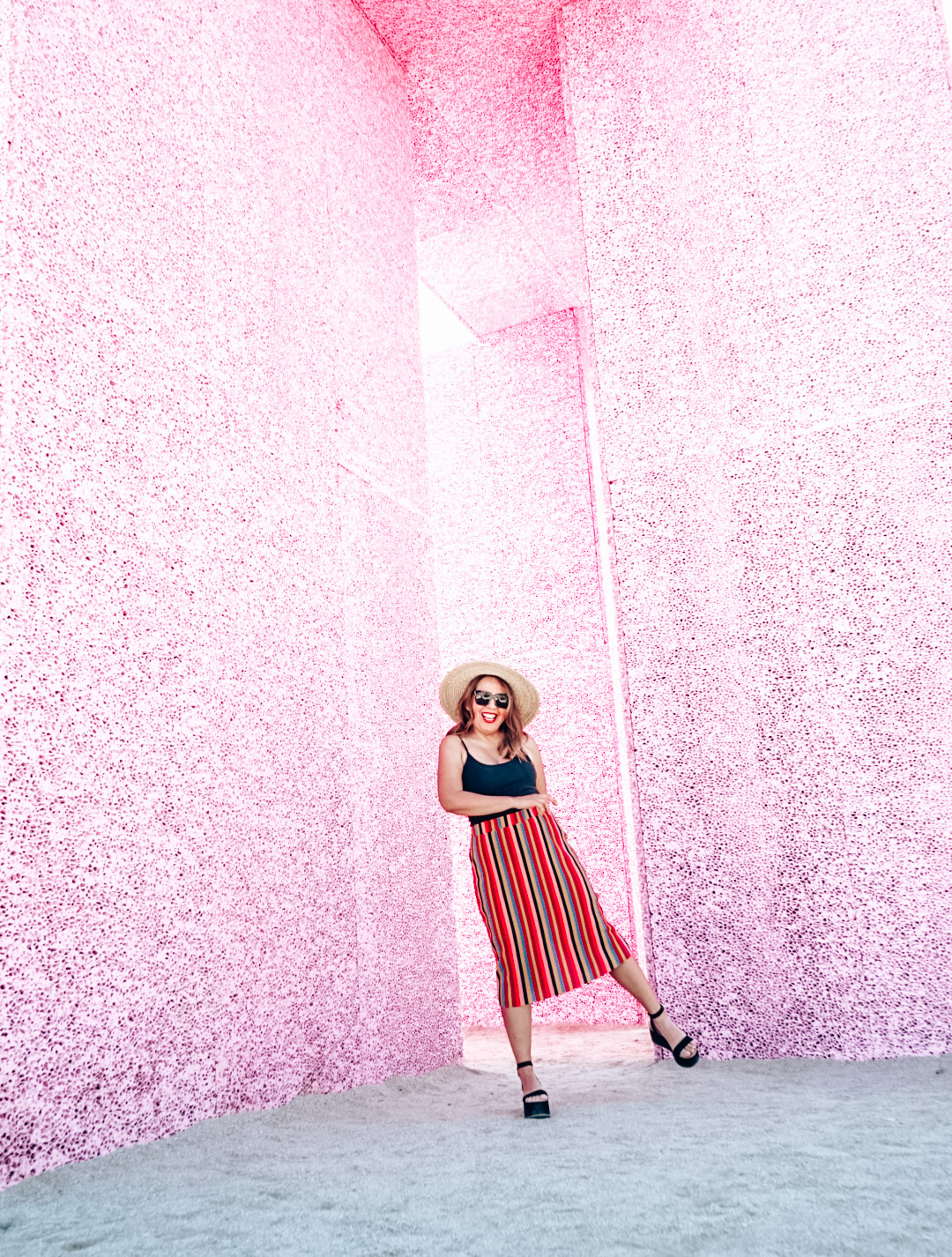 Girl dancing at the Superflex 2019 wearing striped midi skirt and sun hat. 