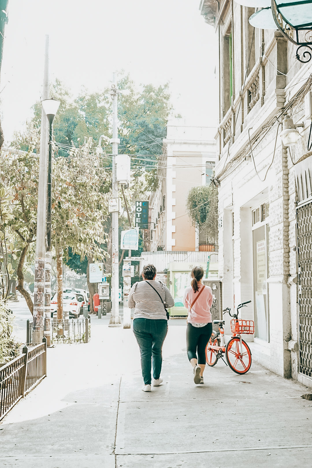 Two women walking in the city of Roma Norte. 