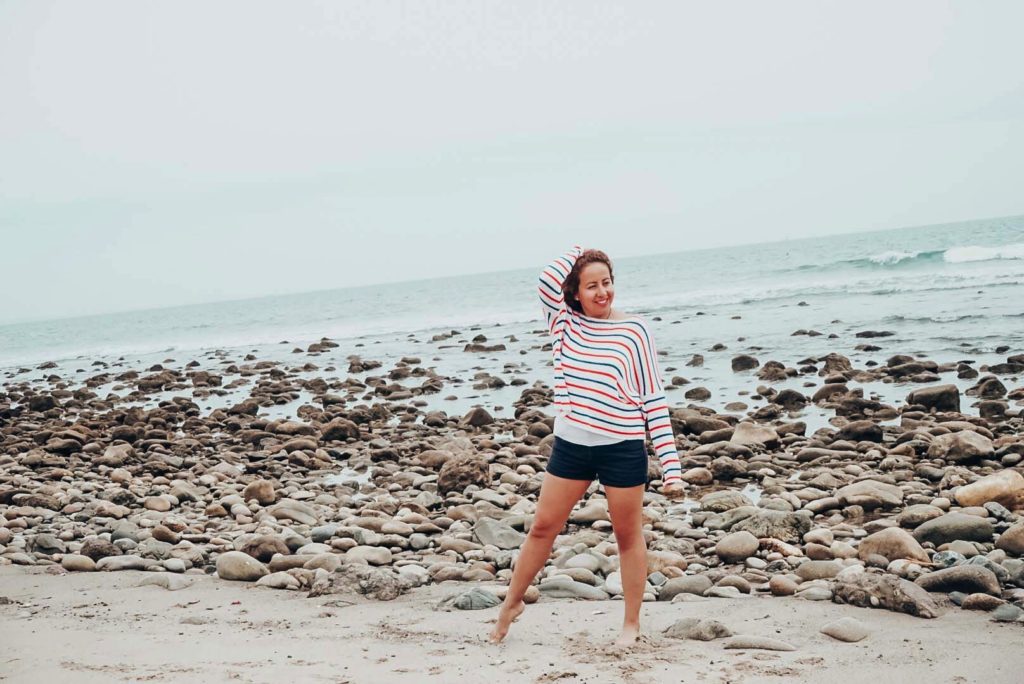 Striped sweater for 4th of July celebrations worn by a girl at the beach.