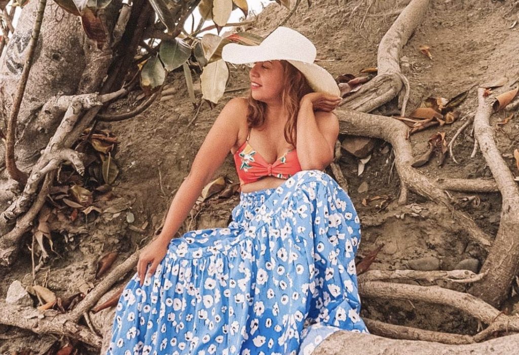 Living life with purpose and style. Spending time at the beach, wearing a long tiered skirt with bikini top.