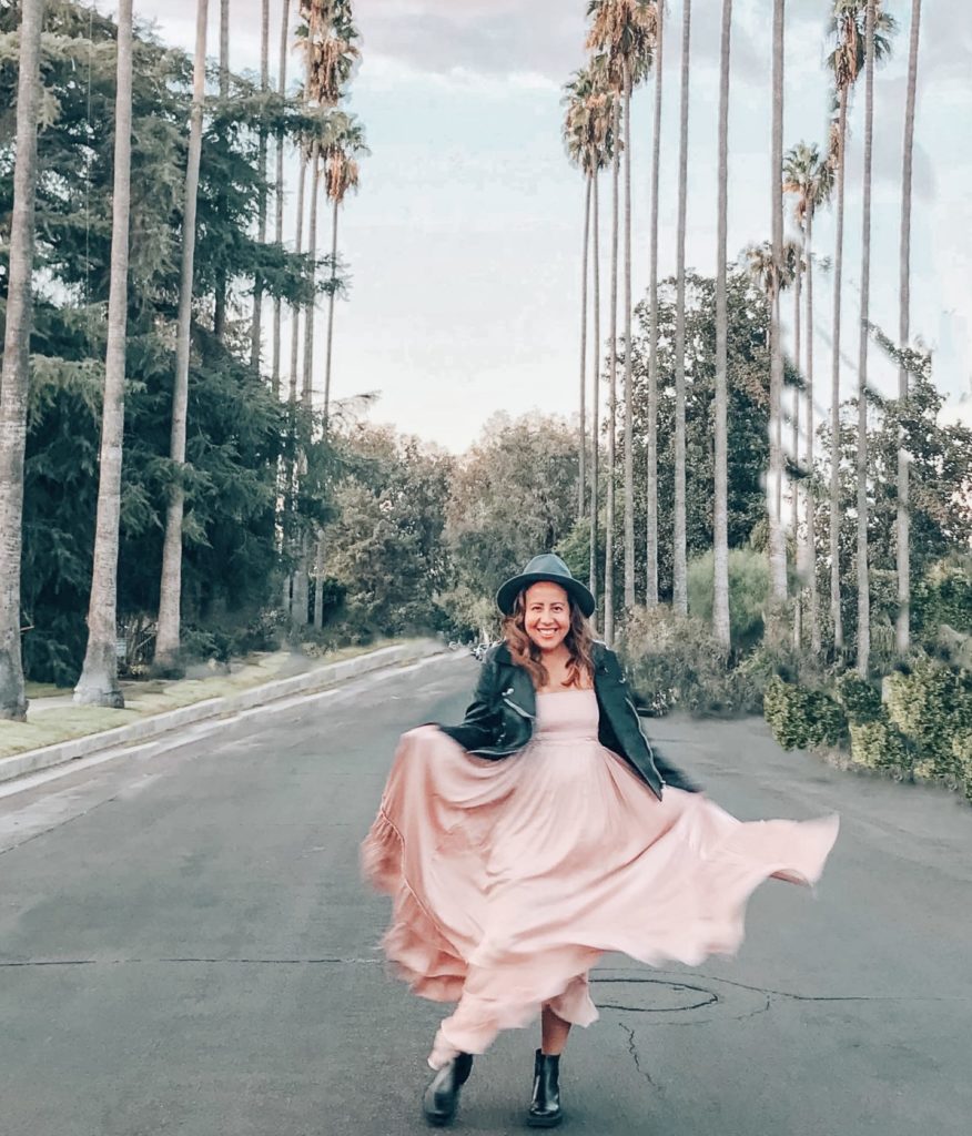 A black biker jacket adds an edge to any look, even a pink ruffled maxi dress.